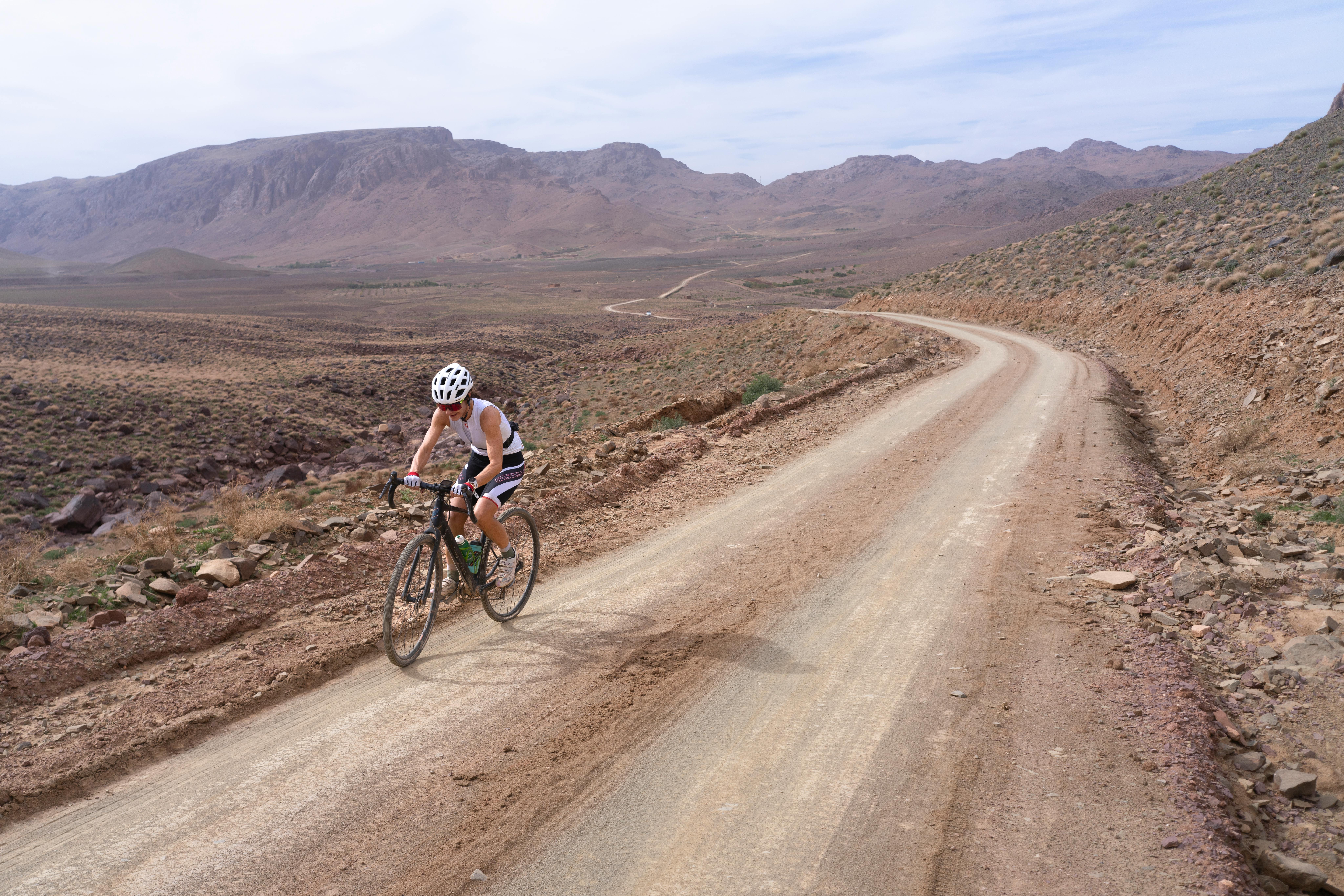 Cyclist alone on a long road in Africa